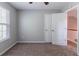 This cozy bedroom features plush carpeting, a bright window, and ample closet space at 6757 Delaware Bnd, Fairburn, GA 30213