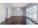 Spacious dining room with hardwood flooring and abundant natural light from a large window at 6757 Delaware Bnd, Fairburn, GA 30213