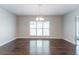 Open dining room with hardwood floors and a view of the backyard at 6757 Delaware Bnd, Fairburn, GA 30213