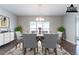 Elegant dining room with hardwood floors, natural light, and contemporary décor at 6757 Delaware Bnd, Fairburn, GA 30213