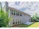 Back exterior view of a two story home with a patio and many windows at 6757 Delaware Bnd, Fairburn, GA 30213
