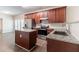 Modern kitchen boasts stainless appliances, granite countertops, and an island, perfect for cooking at 6757 Delaware Bnd, Fairburn, GA 30213