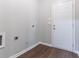 A practical laundry area featuring wood-look flooring and a convenient exterior door at 6757 Delaware Bnd, Fairburn, GA 30213