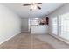Open living room with carpeted floor and view into the kitchen area at 6757 Delaware Bnd, Fairburn, GA 30213
