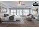 Well-staged main bedroom with a large bed, neutral colors, and a tray ceiling at 6757 Delaware Bnd, Fairburn, GA 30213