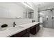 Bathroom featuring double sinks, quartz counters and glass enclosed shower with marble tiling at 821 Ralph Mcgill Ne Blvd # 2412, Atlanta, GA 30306