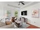Bright living room with hardwood floors, white walls, a ceiling fan and lots of seating at 821 Ralph Mcgill Ne Blvd # 2412, Atlanta, GA 30306