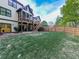 Large backyard with a well-manicured lawn, patio, and wooden fence at 1076 Pinyan Ln, Canton, GA 30115