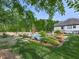 Landscaped backyard featuring a sparkling pool, lush greenery, comfortable lounge area, and privacy fence at 1076 Pinyan Ln, Canton, GA 30115