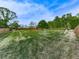 Vast backyard with mature trees and a wooden fence at 1076 Pinyan Ln, Canton, GA 30115