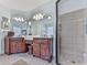 Bathroom with a double sink vanity, large mirrors, and a glass-enclosed shower at 1076 Pinyan Ln, Canton, GA 30115