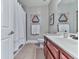 Bathroom features wood vanity with a white countertop, tile flooring, and shower with curtain at 1076 Pinyan Ln, Canton, GA 30115