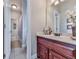 Bathroom features a wood vanity, ample lighting, and tile flooring with decorative accents at 1076 Pinyan Ln, Canton, GA 30115