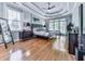 Primary bedroom featuring a tray ceiling, hardwood floors, and lots of natural light at 1076 Pinyan Ln, Canton, GA 30115