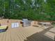 Outdoor wooden deck featuring a stainless steel grill, dining table, and seating area for backyard entertaining at 1076 Pinyan Ln, Canton, GA 30115