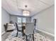 This is a dining room with a glass table, gray chairs, and a light fixture at 1076 Pinyan Ln, Canton, GA 30115