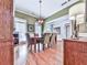 Spacious dining room featuring hardwood floors, crown molding, and a decorative light fixture at 1076 Pinyan Ln, Canton, GA 30115