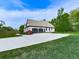 Beautiful home featuring a long concrete driveway, two-car garage, and well-manicured lawn at 1076 Pinyan Ln, Canton, GA 30115