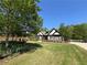 Attractive home with a well-maintained lawn, landscaping, and traditional design at 1076 Pinyan Ln, Canton, GA 30115