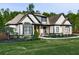 Well-kept single Gathering home displaying stone and black trim accents with a manicured lawn at 1076 Pinyan Ln, Canton, GA 30115