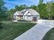 Charming two-story home with a well-manicured lawn and long driveway, perfect for families at 1076 Pinyan Ln, Canton, GA 30115