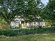 Charming home with lush landscaping, a yellow door, and a well-manicured lawn at 1076 Pinyan Ln, Canton, GA 30115