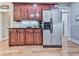 A kitchen area featuring wood cabinets, stainless steel refrigerator, and tiled backsplash at 1076 Pinyan Ln, Canton, GA 30115