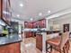 Well-lit kitchen featuring wooden cabinets, granite countertops, stainless steel appliances, and hardwood floors at 1076 Pinyan Ln, Canton, GA 30115