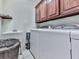 This laundry room features a utility sink, washer and dryer and built-in wood cabinets above the appliances at 1076 Pinyan Ln, Canton, GA 30115