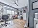 Eclectic living room featuring hardwood floors, abundant natural light, and unique decor at 1076 Pinyan Ln, Canton, GA 30115