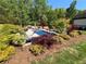 Inviting backyard pool with serene landscaping and mature trees at 1076 Pinyan Ln, Canton, GA 30115