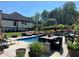 Outdoor swimming pool with patio, furniture, and beautifully landscaped backyard at 1076 Pinyan Ln, Canton, GA 30115