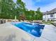 Beautiful in-ground swimming pool with lounge area, patio furniture, and well-manicured landscaping at 1076 Pinyan Ln, Canton, GA 30115