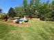 Backyard pool features a secluded setting with lush landscaping at 1076 Pinyan Ln, Canton, GA 30115