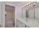 Bathroom featuring a bright vanity with large mirror and views into an adjacent room at 2009 Pine Forest Ct, Jonesboro, GA 30236