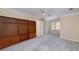 Spacious bedroom with built in bookshelf, neutral carpet, and a ceiling fan at 2009 Pine Forest Ct, Jonesboro, GA 30236