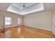 Spacious bedroom with hardwood floors, tray ceiling, and two windows offering natural light at 2009 Pine Forest Ct, Jonesboro, GA 30236