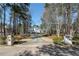 Long driveway leading to a stately home, framed by mature trees and manicured landscaping at 2009 Pine Forest Ct, Jonesboro, GA 30236