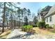 Exterior view of a well-maintained home surrounded by lush landscaping and mature trees at 2009 Pine Forest Ct, Jonesboro, GA 30236