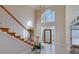 Elegant foyer with a staircase, decorative chandelier, and large windows providing abundant natural light at 2009 Pine Forest Ct, Jonesboro, GA 30236