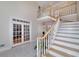 Grand foyer with a staircase and elegant French doors, offering a welcoming entrance at 2009 Pine Forest Ct, Jonesboro, GA 30236