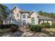 Charming two-story home with arched windows, complemented by mature landscaping and a welcoming entrance at 2009 Pine Forest Ct, Jonesboro, GA 30236