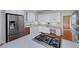 Well-lit kitchen showcasing white cabinets, stainless steel appliances, and large island at 2009 Pine Forest Ct, Jonesboro, GA 30236