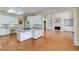 Open concept kitchen features white cabinets, island, and connects to the living room with a fireplace at 2009 Pine Forest Ct, Jonesboro, GA 30236