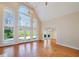 Bright living room with vaulted ceiling, tall windows, and hardwood floors overlooking backyard at 2009 Pine Forest Ct, Jonesboro, GA 30236