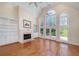 Bright living room with large windows, fireplace, and built-in shelving, ideal for entertaining at 2009 Pine Forest Ct, Jonesboro, GA 30236