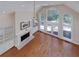 Bright living room with fireplace, built-in shelves, hardwood floors, and high vaulted ceilings at 2009 Pine Forest Ct, Jonesboro, GA 30236