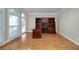 Spacious office featuring built-in wooden shelves, hardwood floors, and two large windows at 2009 Pine Forest Ct, Jonesboro, GA 30236