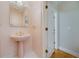 Charming powder room features a pedestal sink and white tile floors at 2009 Pine Forest Ct, Jonesboro, GA 30236