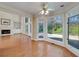 Sunroom with large windows overlooking a yard and fireplace with surrounding shelving at 2009 Pine Forest Ct, Jonesboro, GA 30236